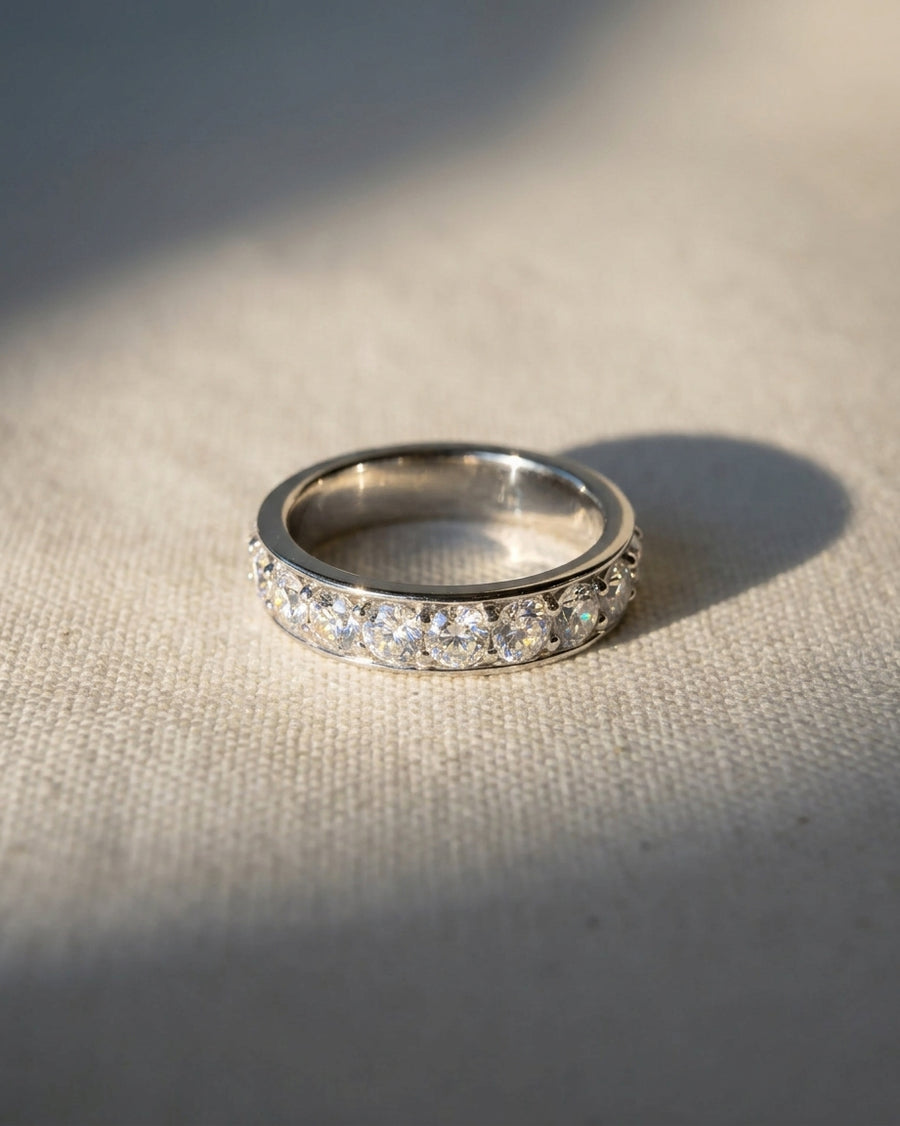 Platinum pavé diamond ring with a row of round diamonds.