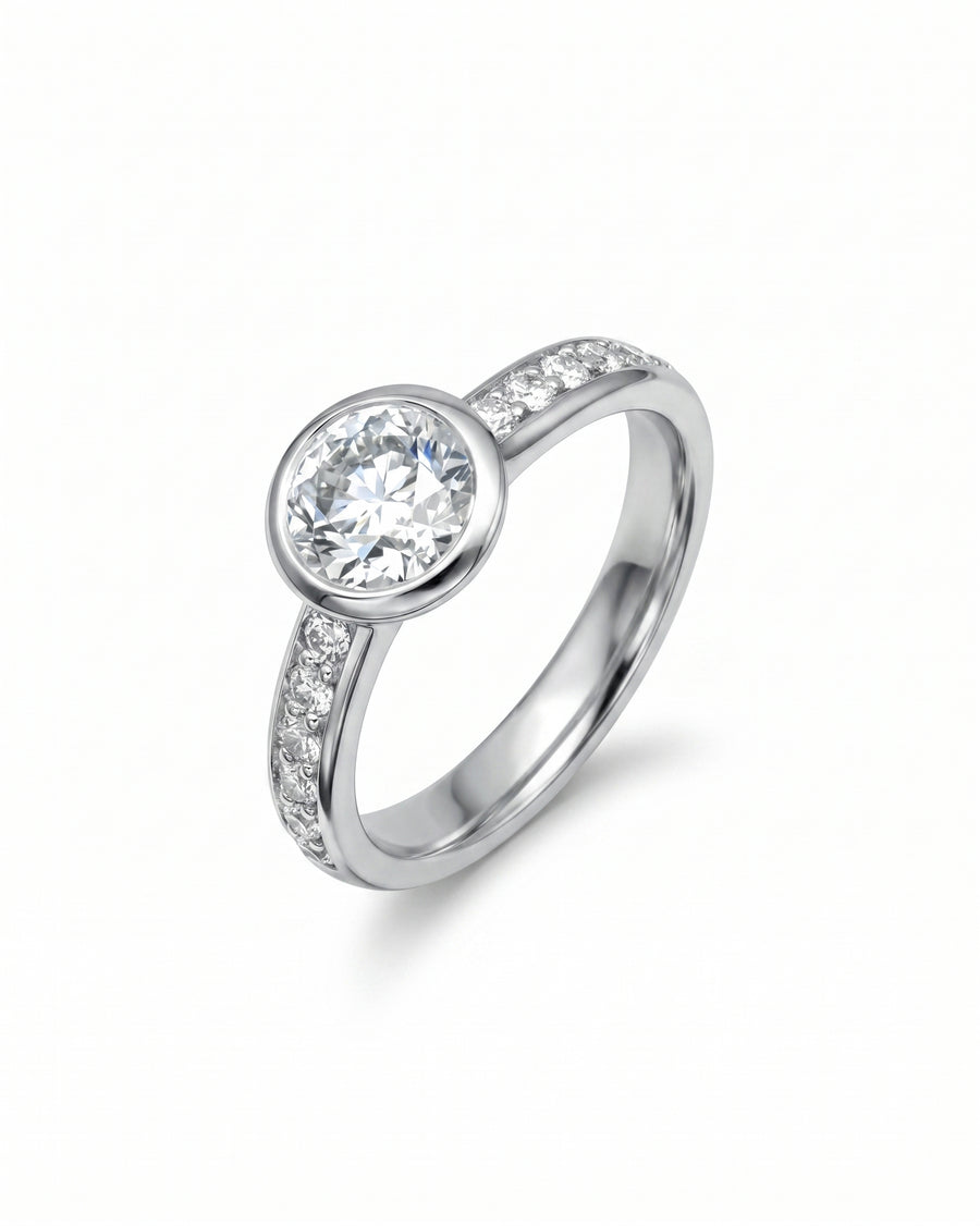 Silver pavé rub over diamond engagement ring with a round center stone.