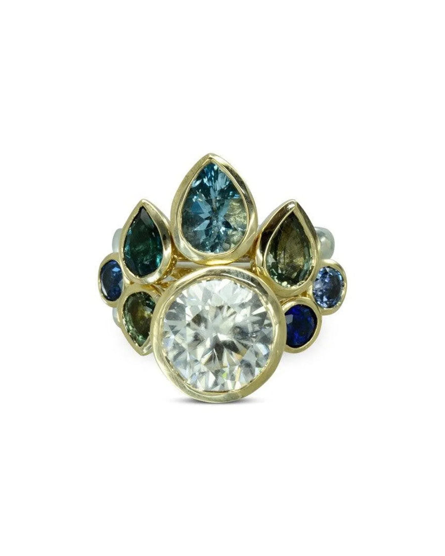 Gold stacking ring set with blue sapphires and diamond, arranged in a peacock-inspired design
