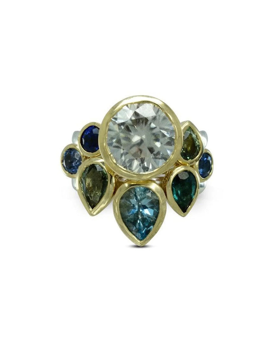Gold stacking ring set with blue sapphires and a large central gemstone