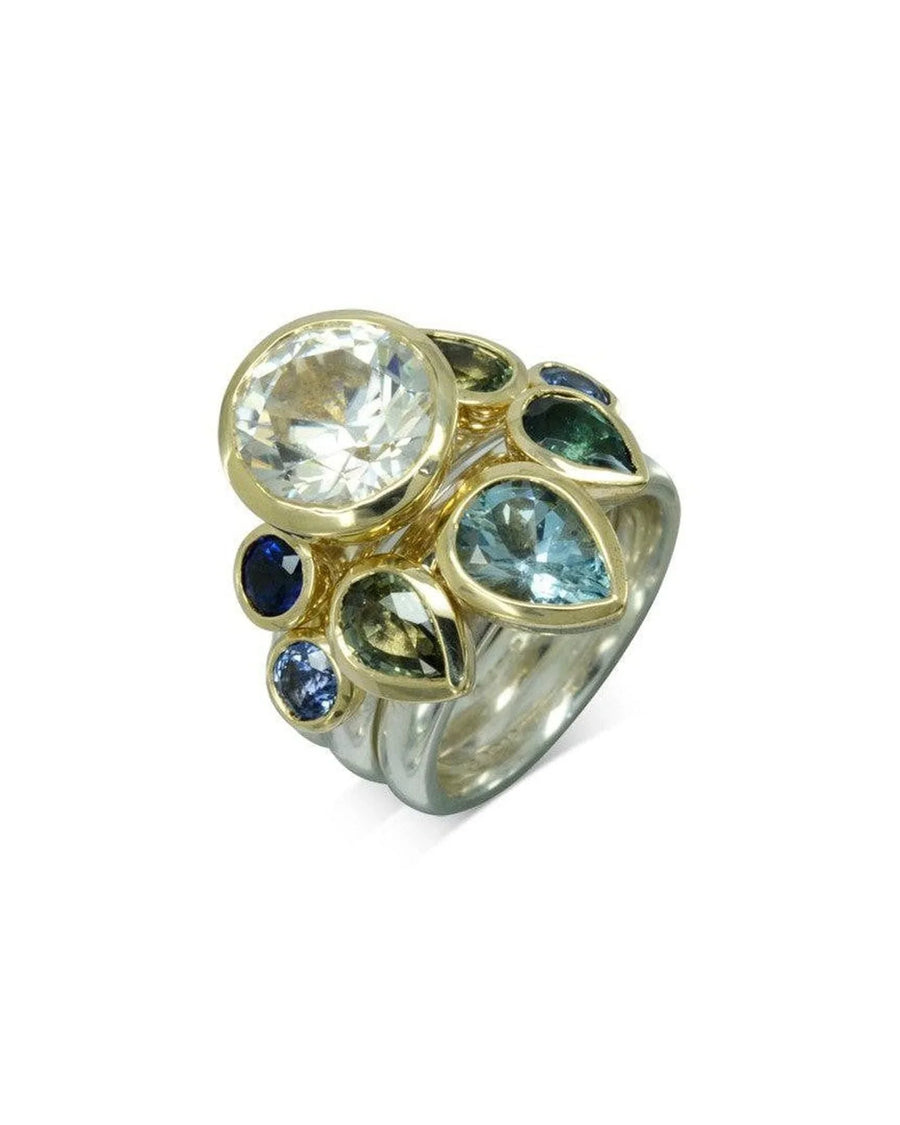 Sapphire stacking ring set with blue and green gemstones in gold and silver bands