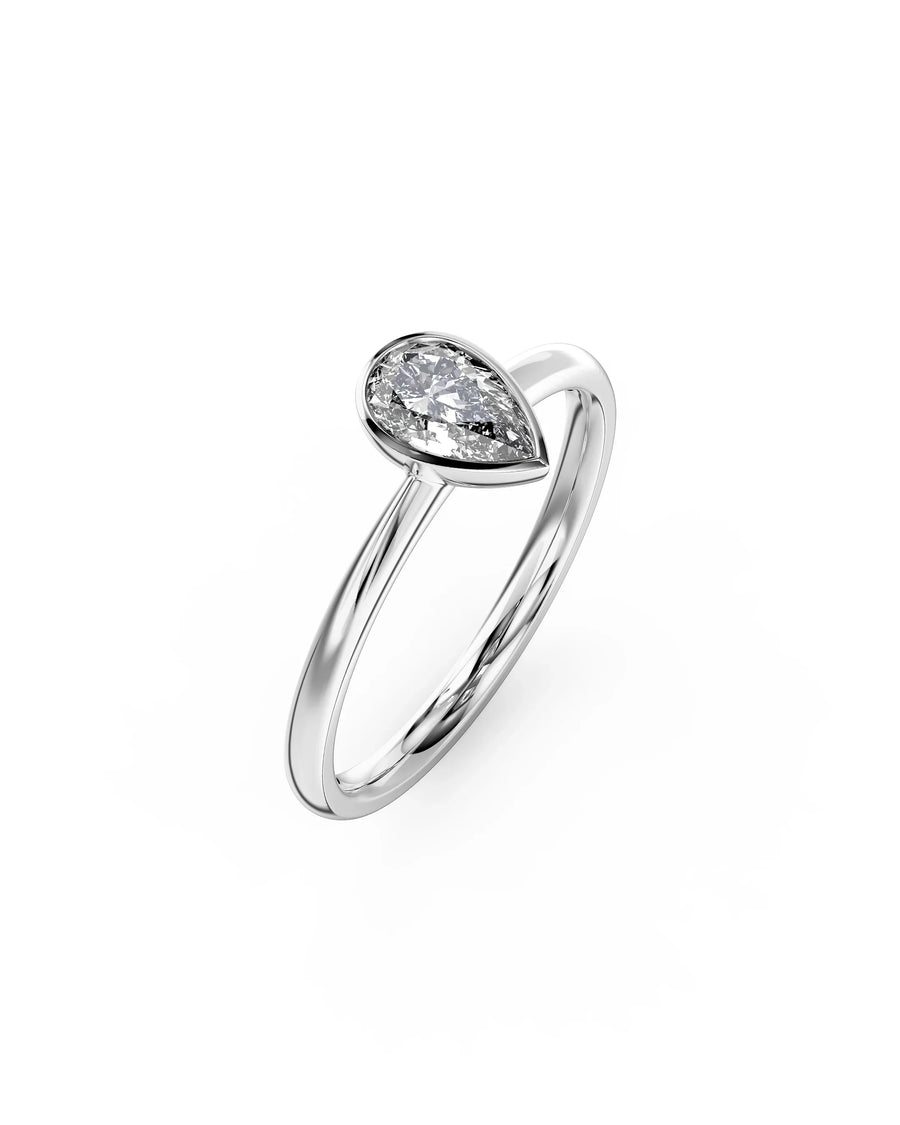 Silver pear cut bezel engagement ring with a diamond.