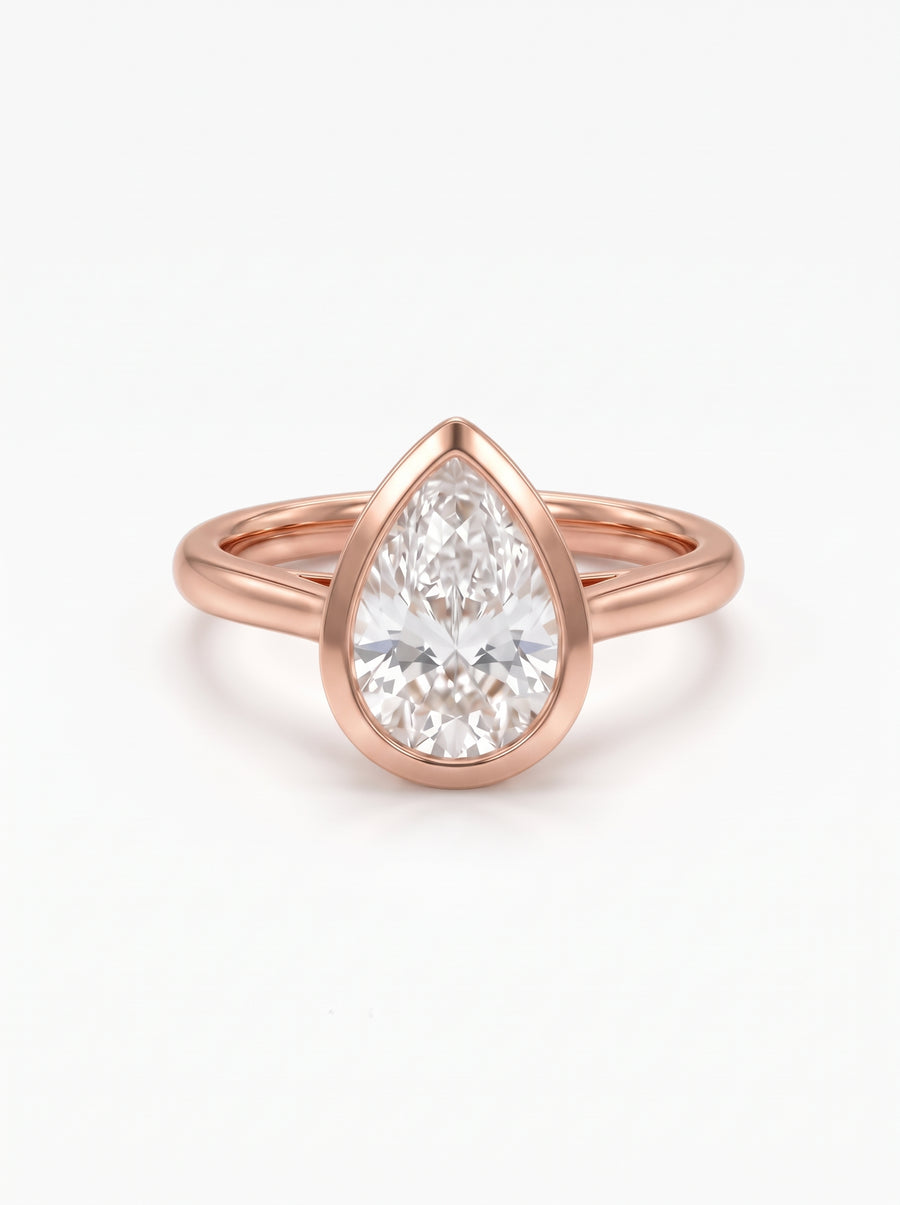 Pear cut diamond engagement ring in 18ct rose gold with a smooth bezel setting.