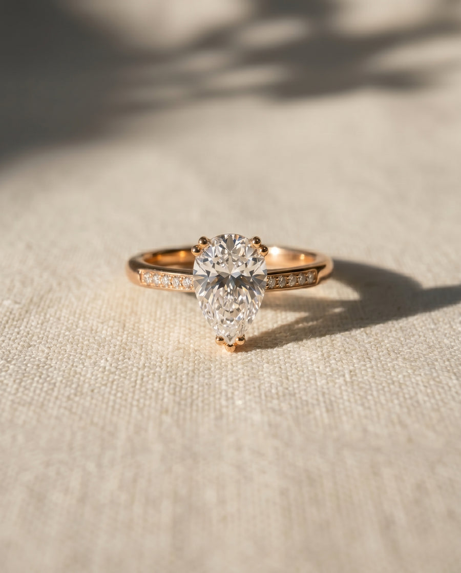 18ct rose gold pear cut hidden halo engagement ring with a 1ct lab grown diamond.