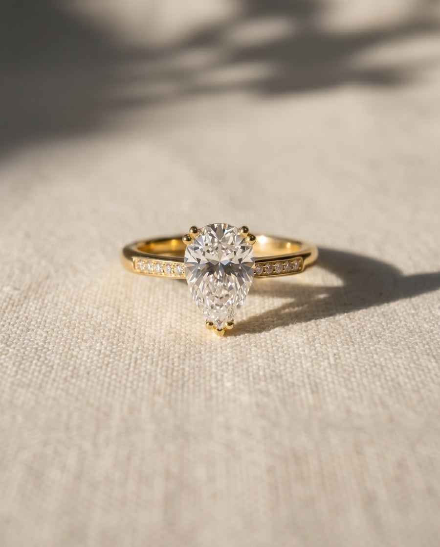 18ct yellow gold pear cut hidden halo engagement ring with a 1ct lab grown diamond.