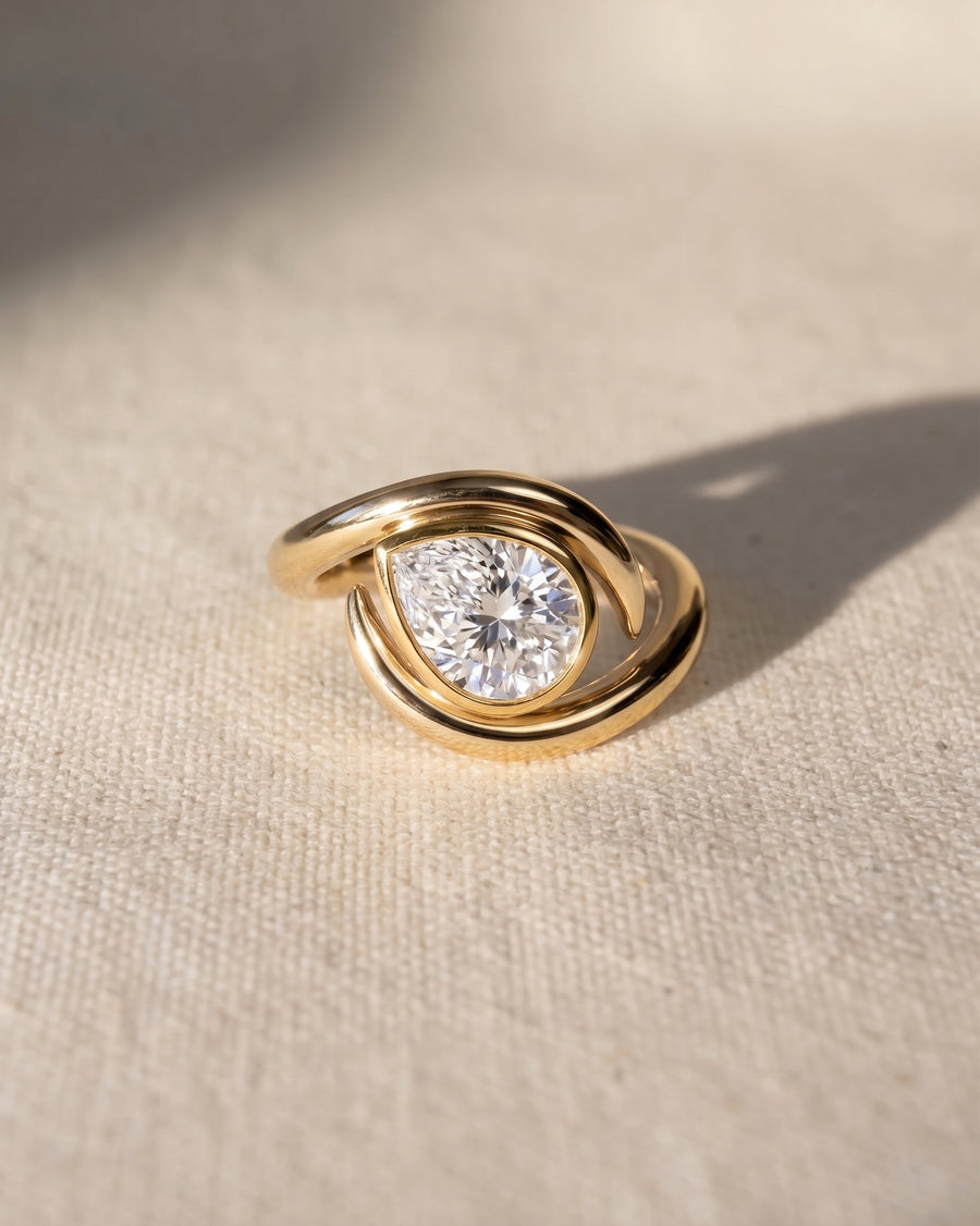 18ct yellow gold engagement ring with a pear cut lab grown diamond.