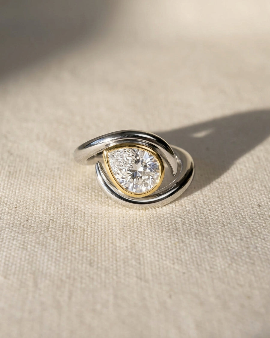 Platinum and yellow gold ring with a pear-cut lab grown diamond.