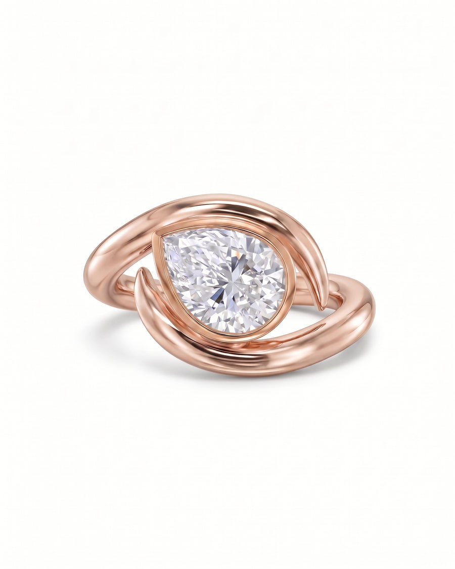 Pear cut diamond engagement ring in 18ct rose gold with a spiky, wrap-around band design.