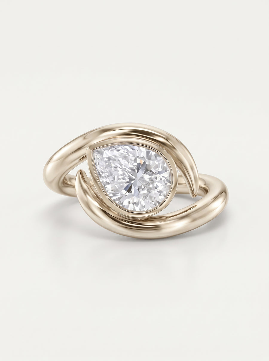 Pear cut diamond engagement ring in 9ct white gold with a curved, spiky bypass band design.