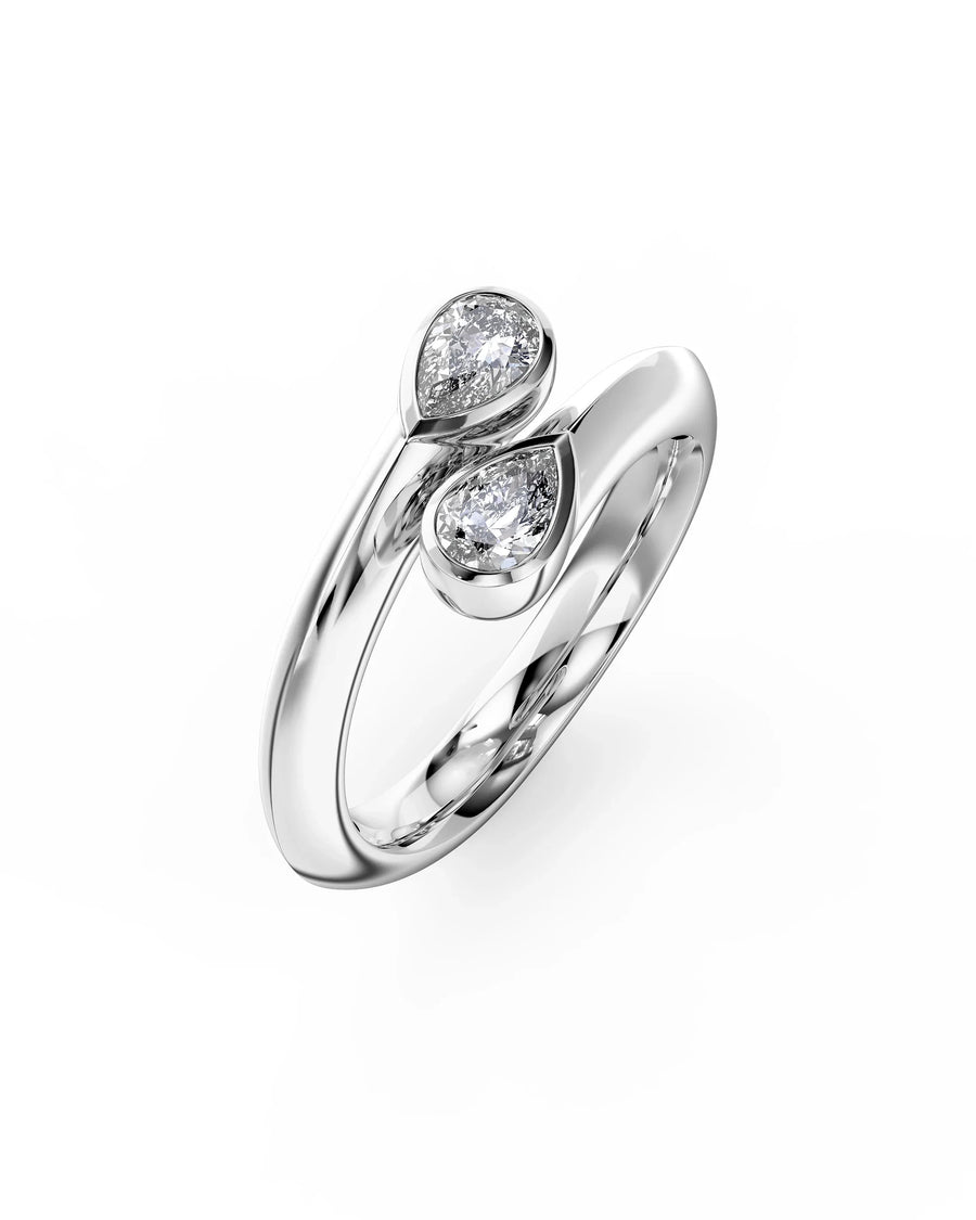 Silver toi et moi engagement ring featuring two pear-cut diamonds in a bypass setting.