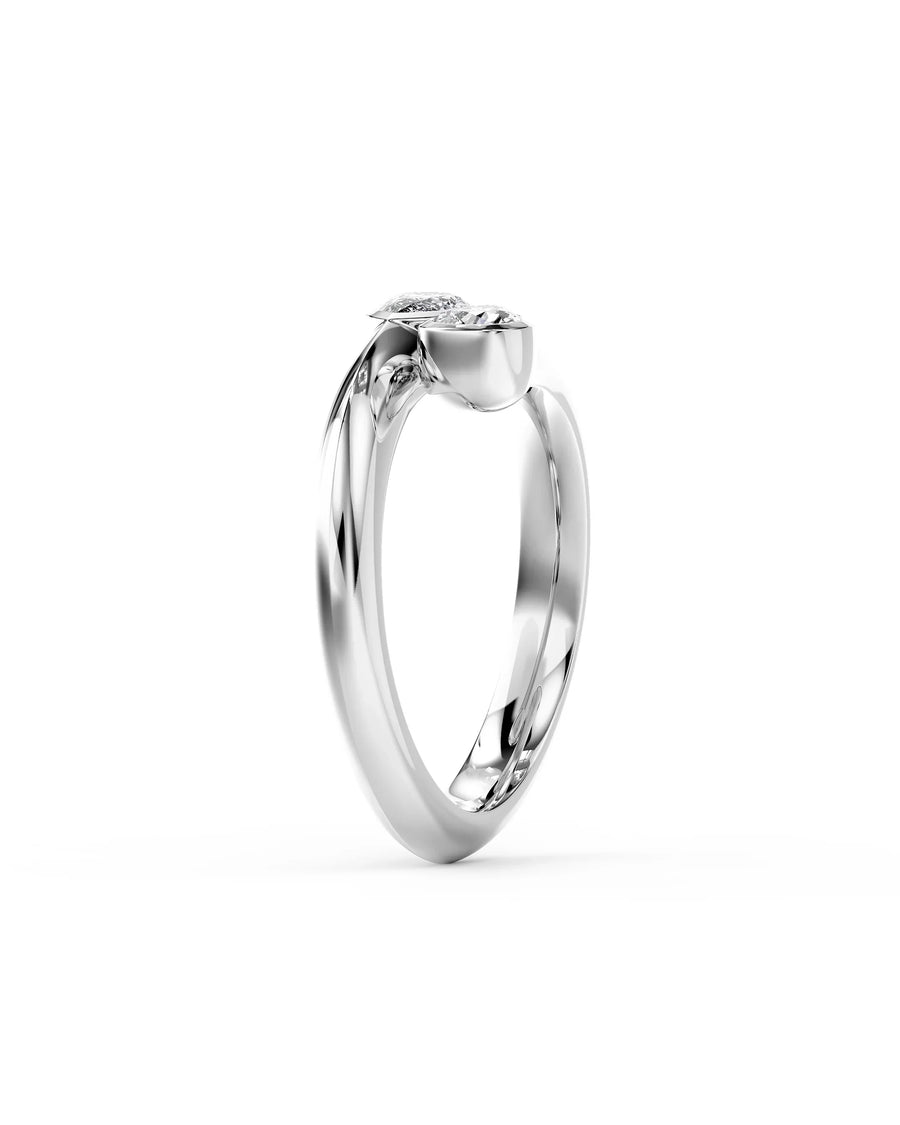 Silver toi et moi engagement ring featuring two pear-cut diamonds set on a polished white gold band.