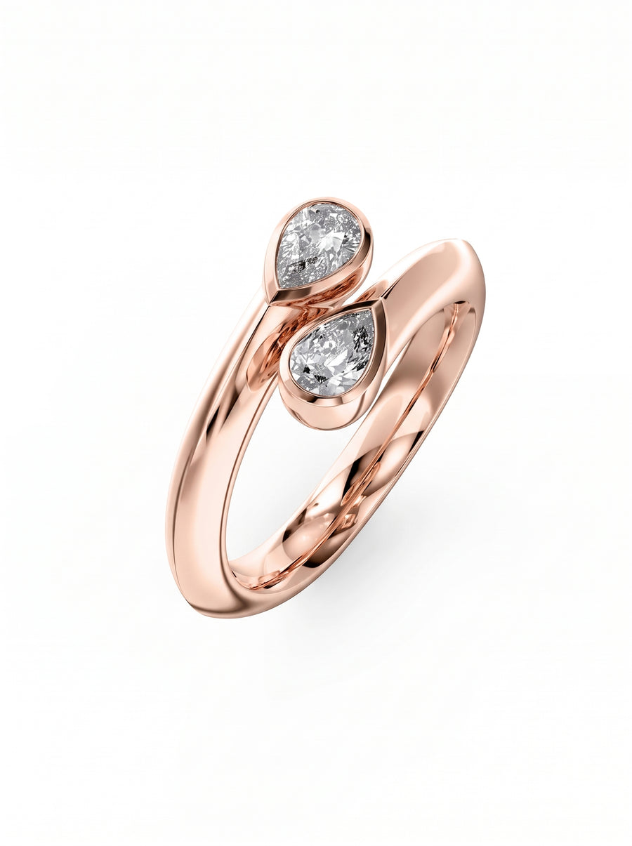 Rose gold toi et moi ring featuring two pear-cut diamonds in a bypass setting.