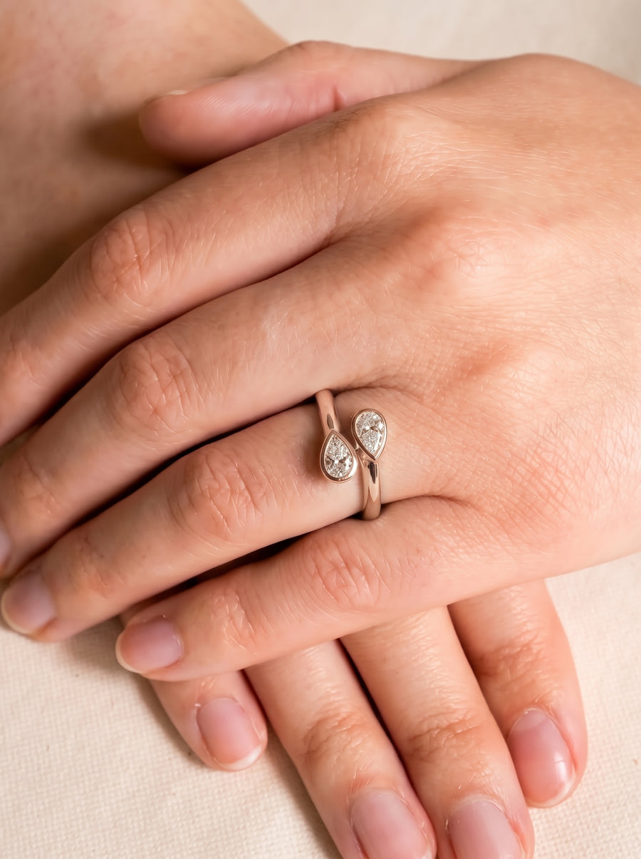 Dainty rose gold toi et moi ring featuring two pear-cut diamond accents on a delicate open band.