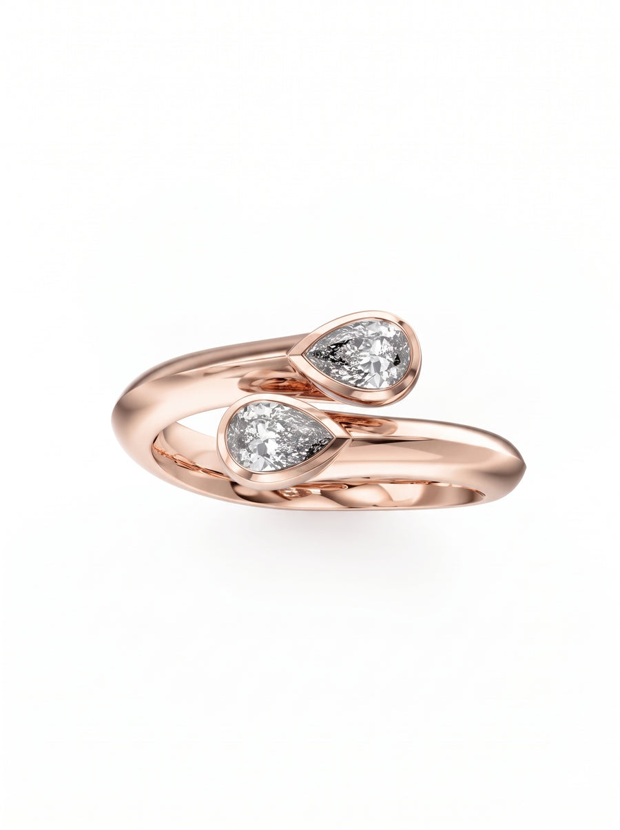 Rose gold toi et moi ring featuring two pear-cut diamonds in a bypass setting.