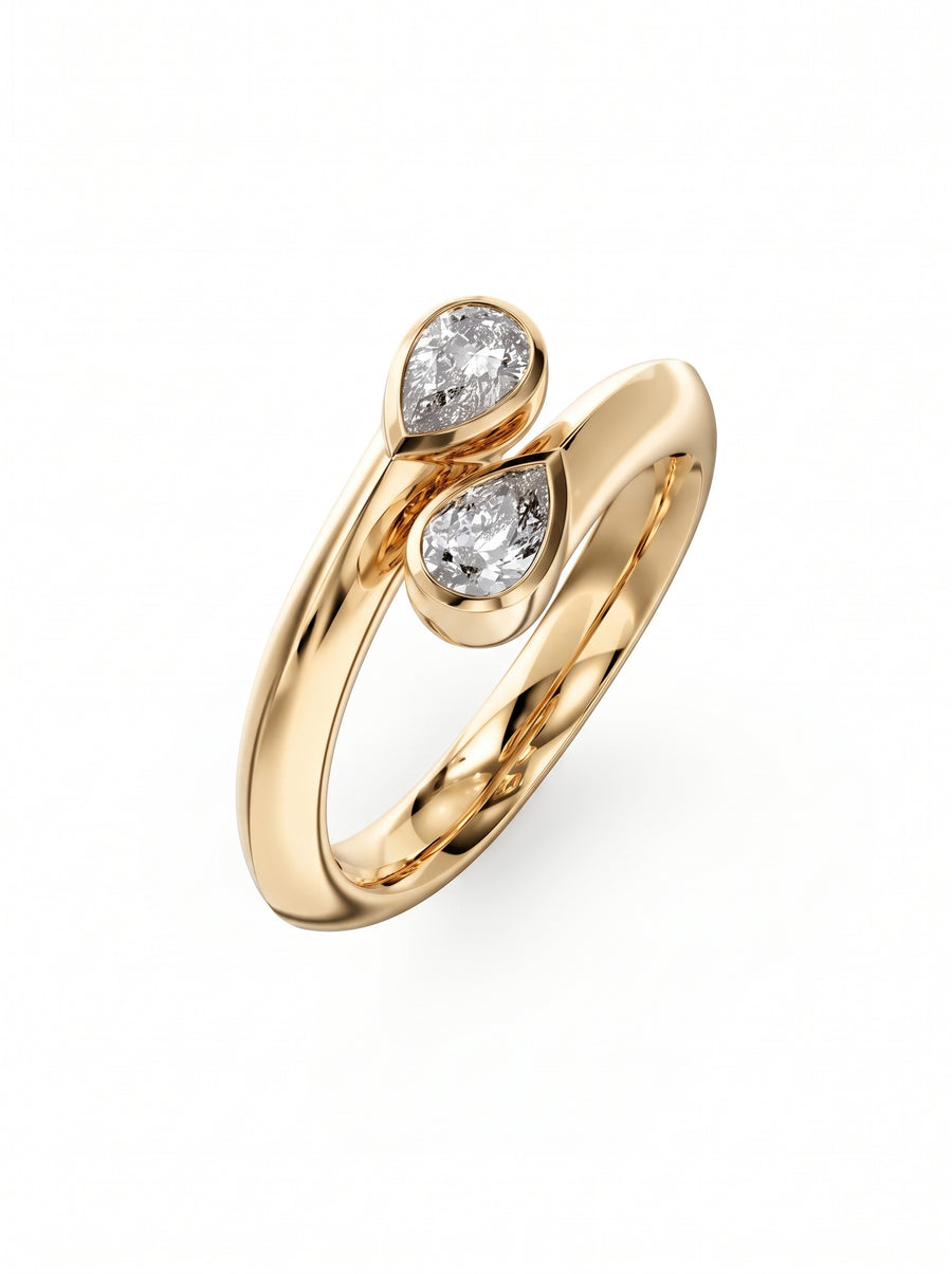 Gold toi et moi ring featuring two pear-cut diamonds in a bezel setting on a polished band.