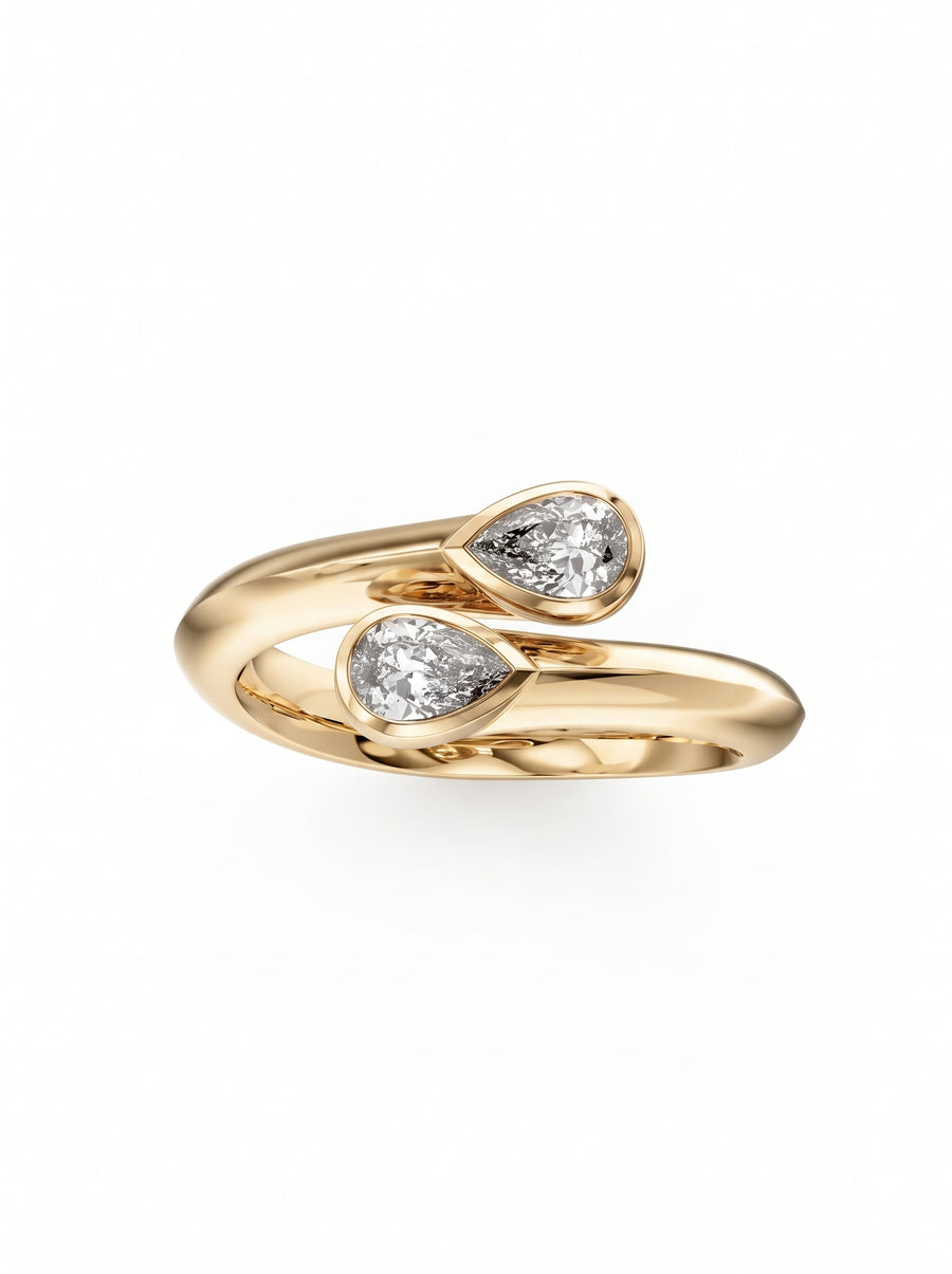 Gold toi et moi engagement ring featuring two pear-cut diamonds in a bypass setting.