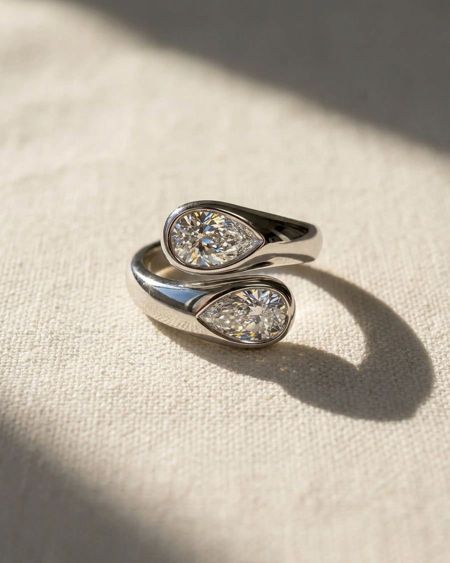 Platinum pear cut toi et moi engagement ring with two lab grown diamonds.