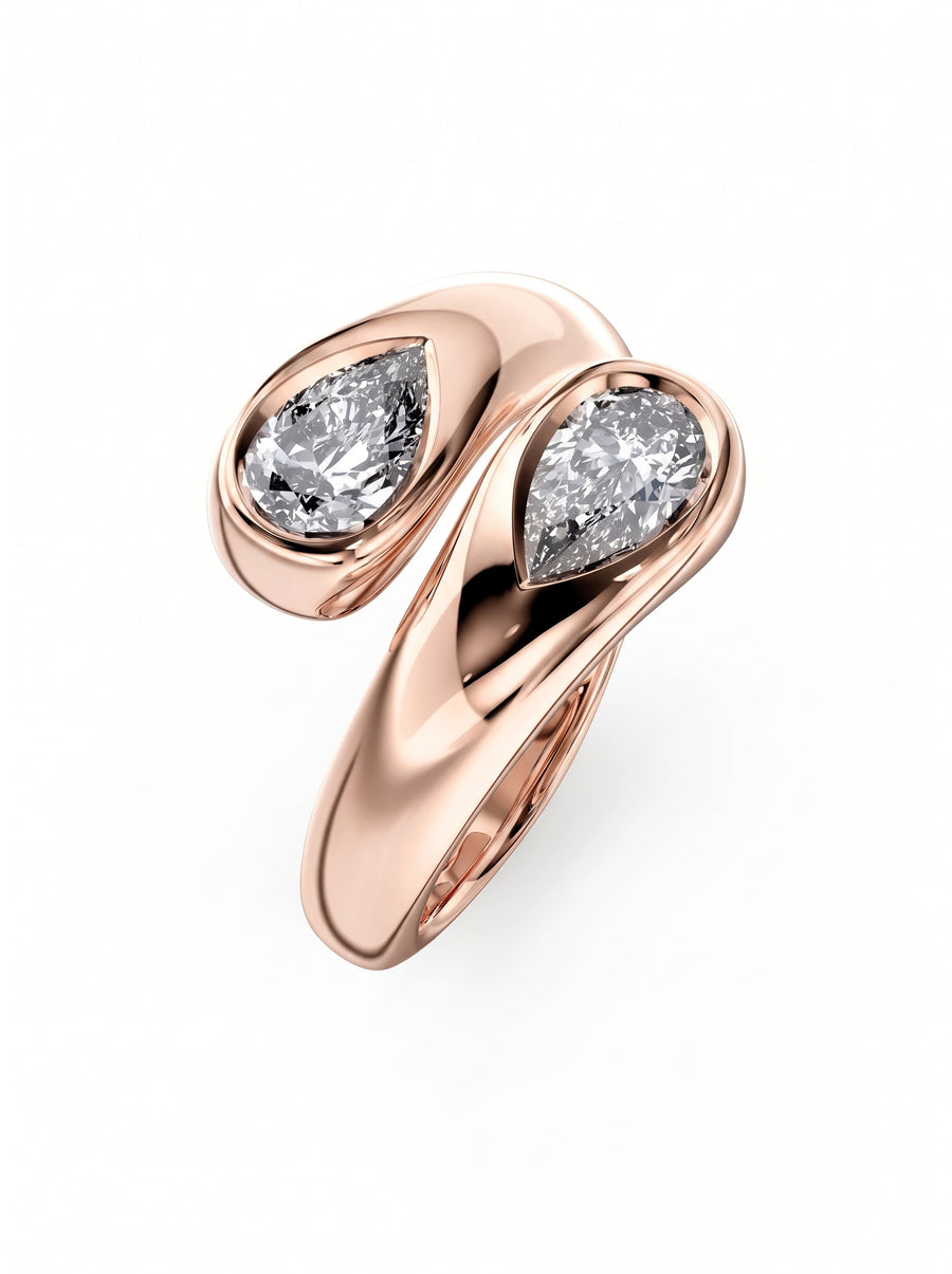 Rose gold toi et moi engagement ring featuring two pear-cut diamonds in bezel settings.