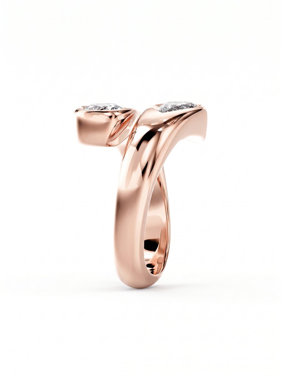 Rose gold toi et moi engagement ring featuring two pear cut diamonds in a bypass setting.