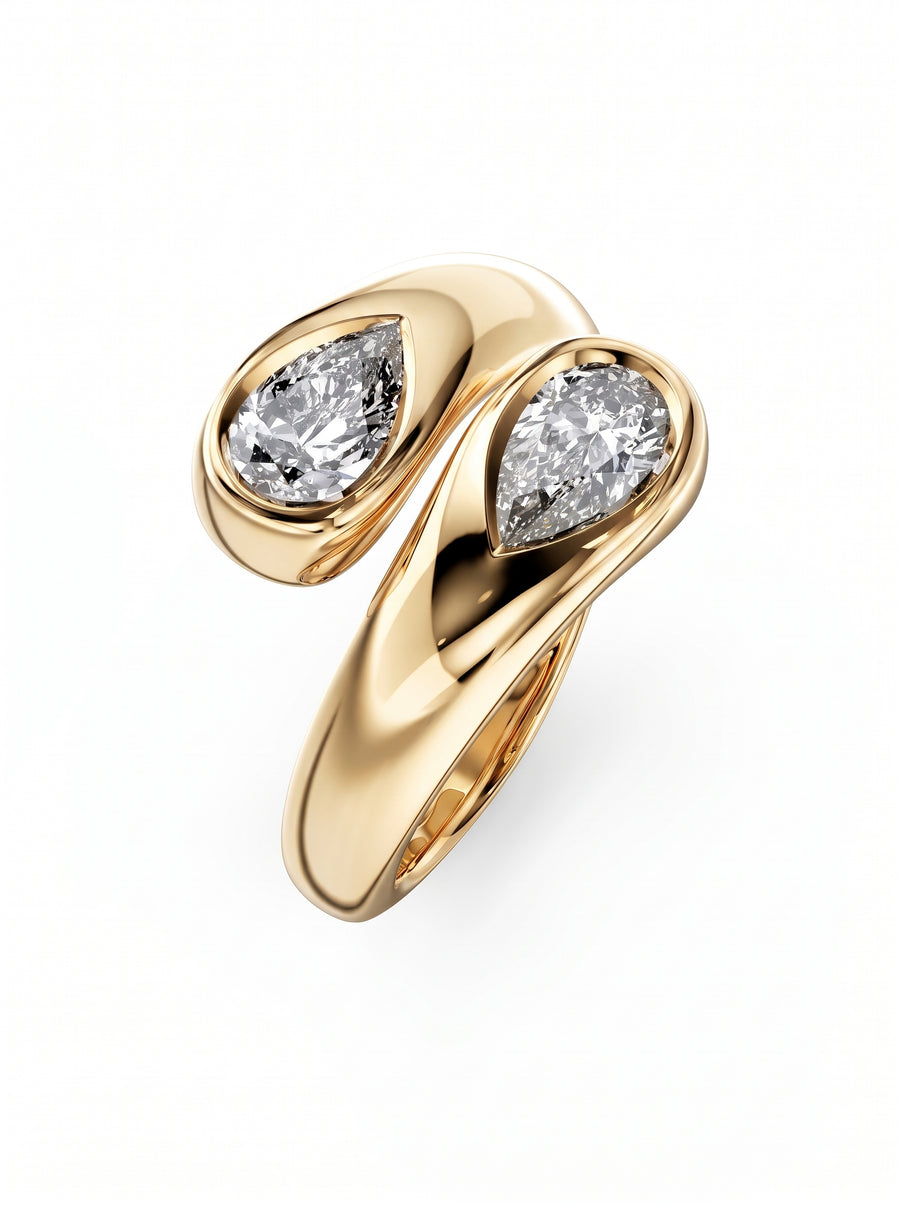Gold toi et moi engagement ring featuring two pear-cut diamonds in bezel settings.