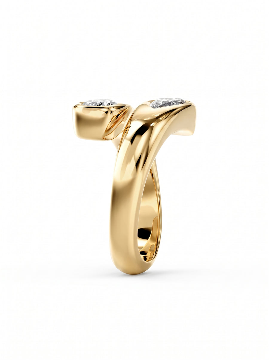 Gold toi et moi engagement ring featuring two pear-cut diamonds in a bypass setting.