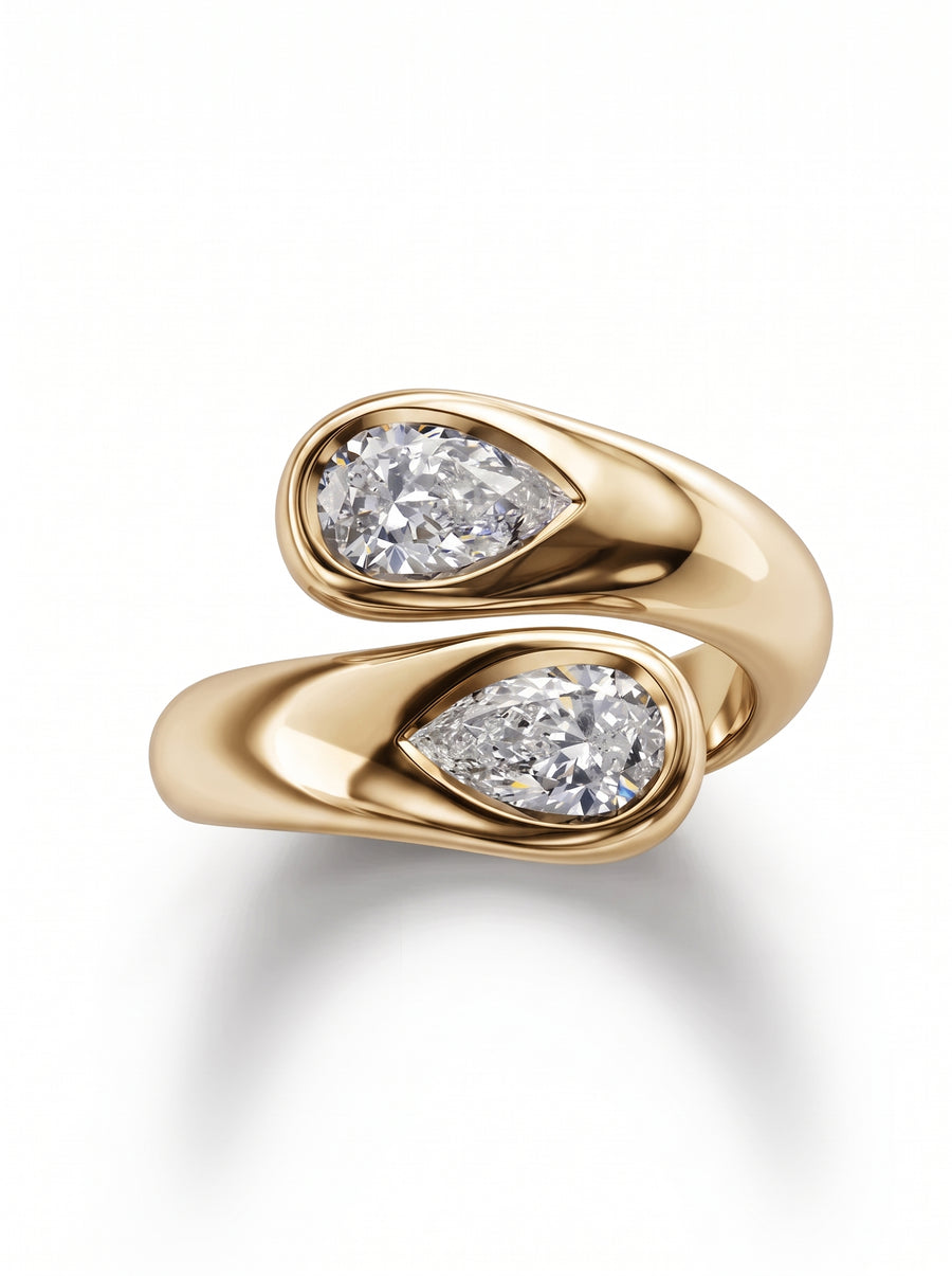 Gold toi et moi engagement ring featuring two pear-cut diamonds in a bypass setting.