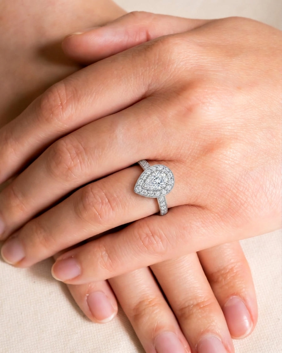 White gold engagement ring with a pear-shaped diamond cluster.