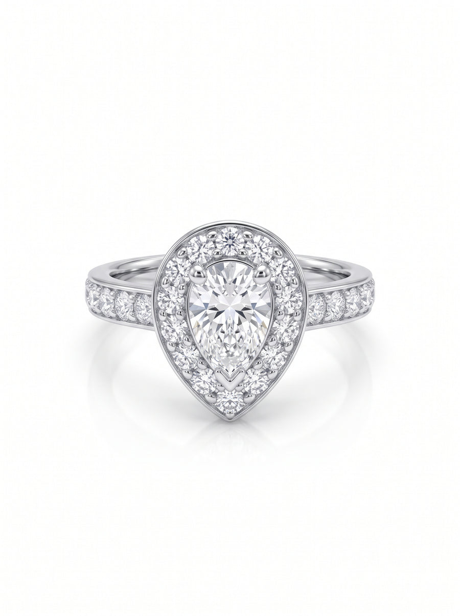 Pear shaped diamond cluster engagement ring in white gold with pavé set diamonds on the band.