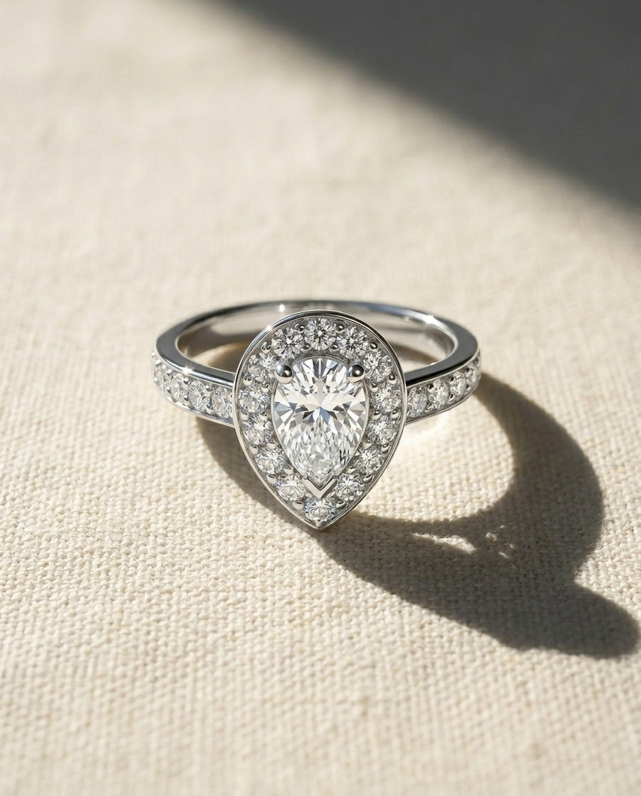 Platinum pear shaped diamond cluster engagement ring.