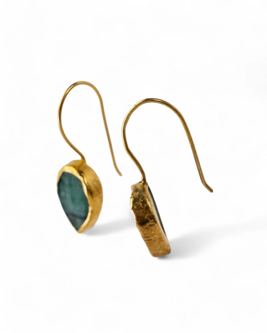 Rough emerald drop earrings with organic gold settings, handcrafted style on white background