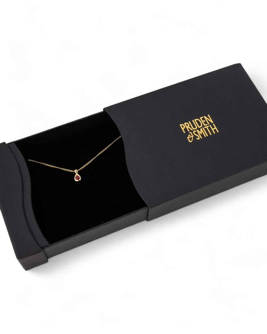 Pear-shaped 9ct yellow gold ruby pendant necklace in black jewellery box
