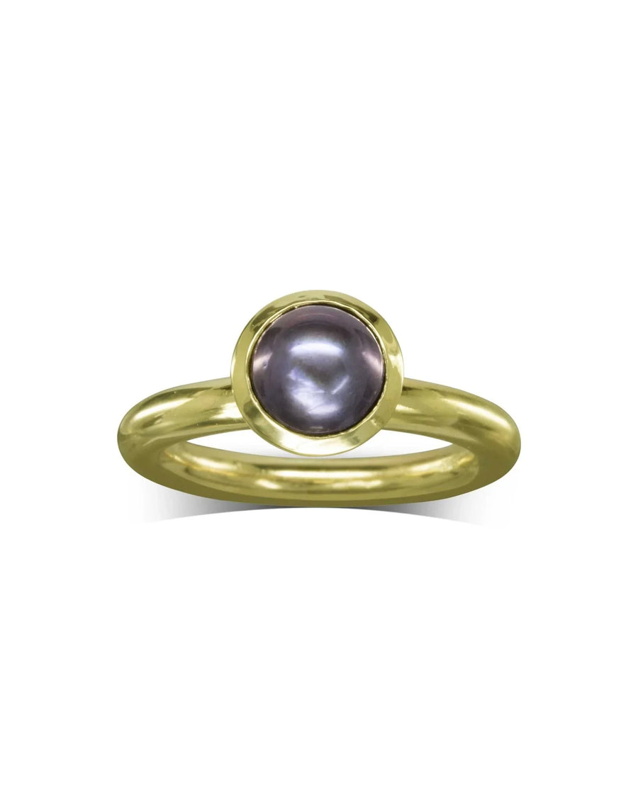 Gold ring with a round, dark purple pearl in a bezel setting.