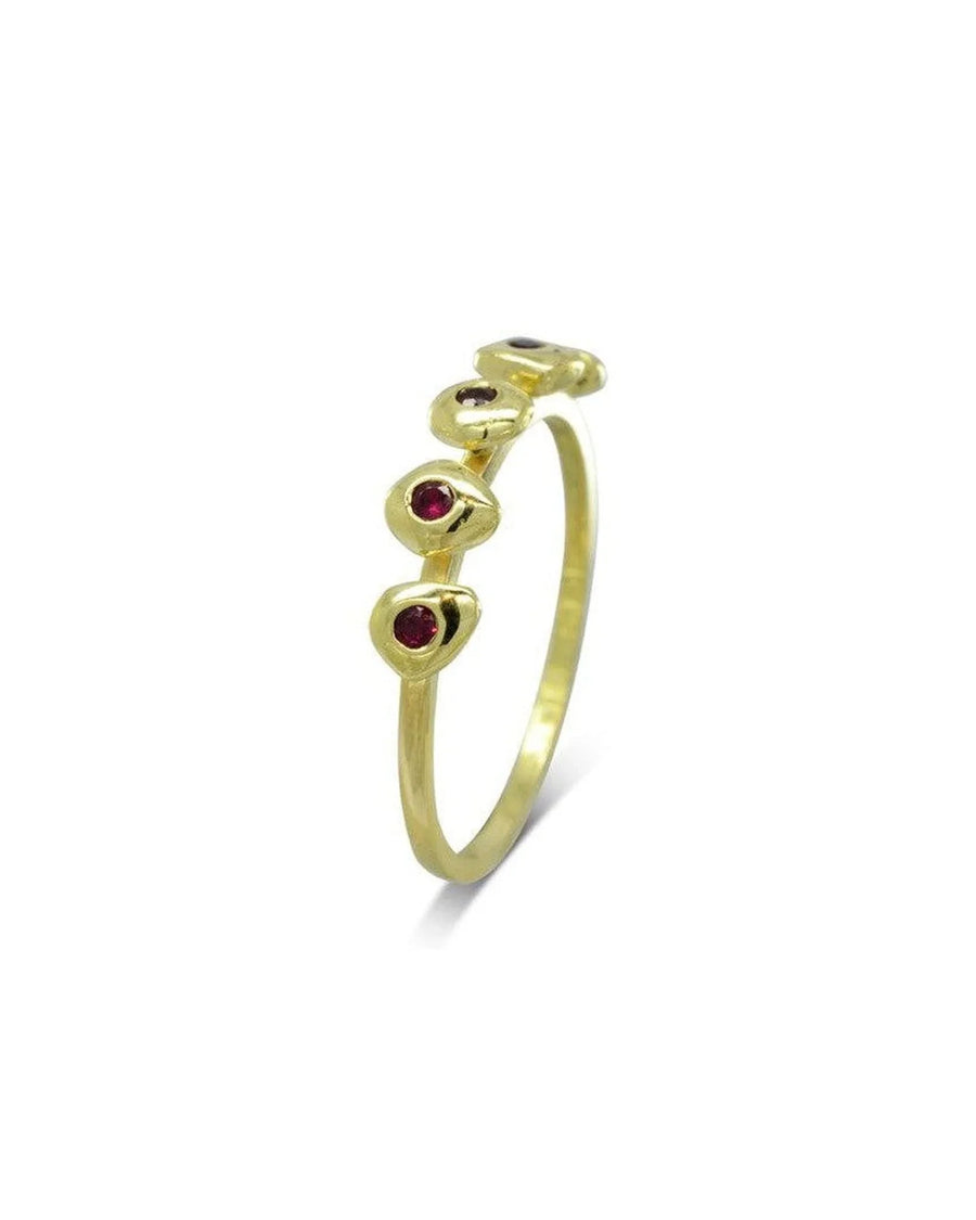 Yellow gold birthstone ring with four organic pebble-shaped settings and red gemstones