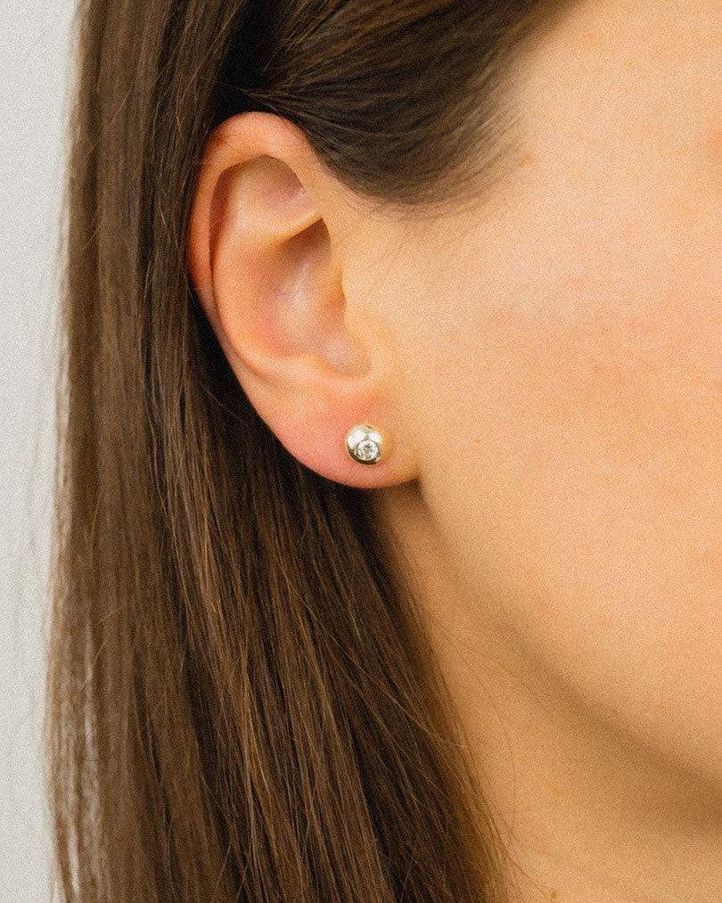Organic white gold diamond stud earring on ear, handmade luxury jewellery, close-up