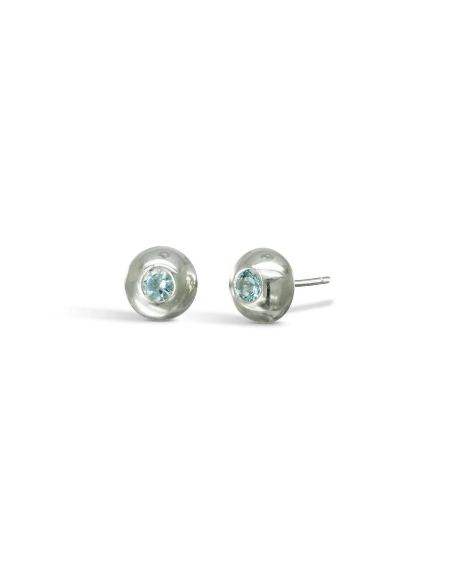 Pebble-inspired white gold gemstone stud earrings with blue stones on a white background