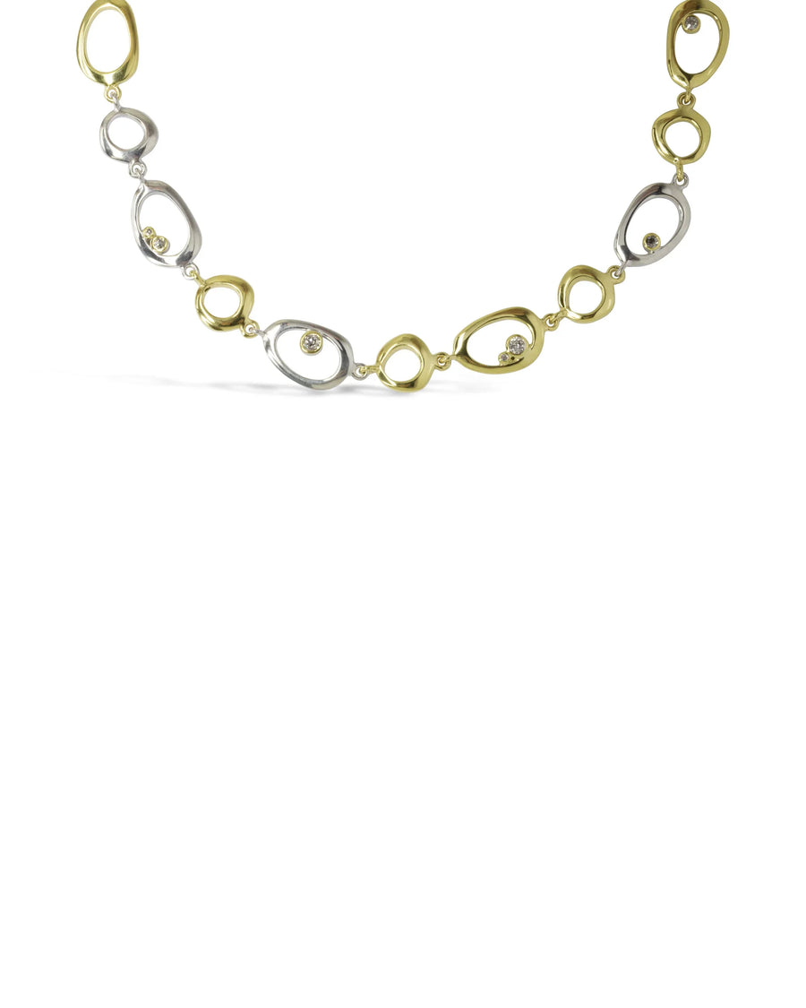 Organic gold and silver pebble necklace with diamonds on white background, luxury handmade jewellery