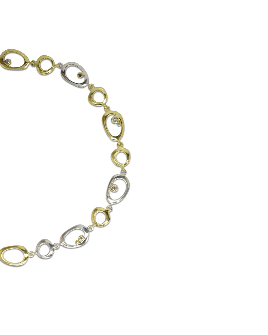 Organic pebble necklace with yellow and white metal links and scattered diamonds
