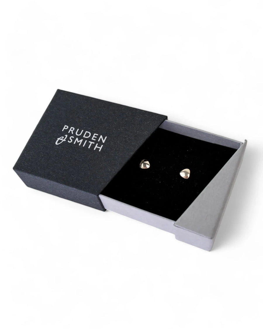 Pebble-shaped silver stud earrings displayed in a black velvet gift box