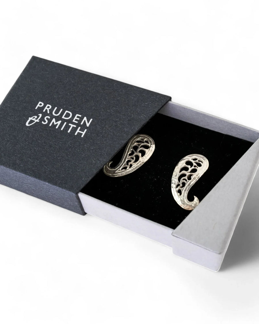 Paisley stud earrings with pierced detailing in silver, presented in a gift box