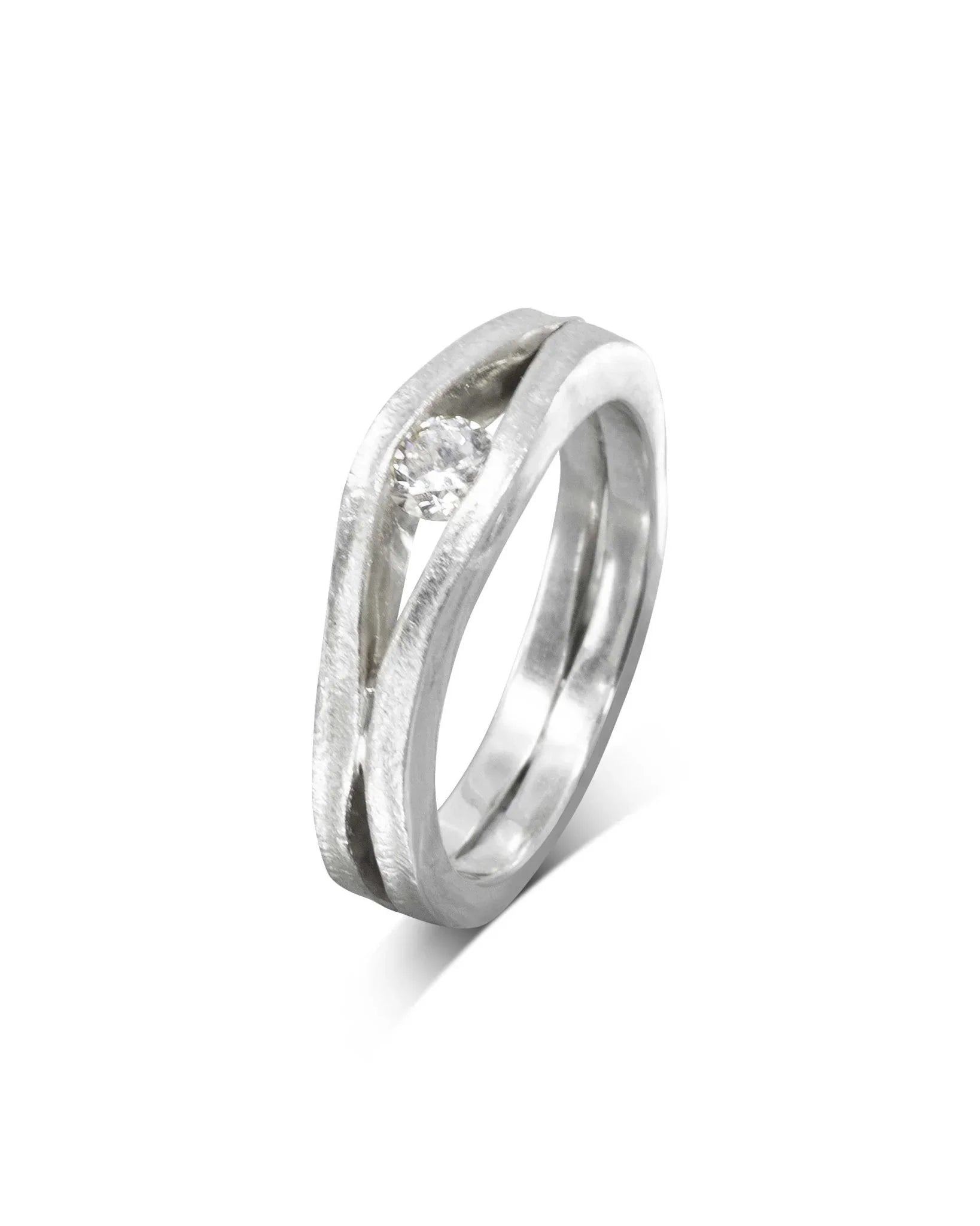 Platinum engagement ring with a round diamond in a trap solitaire design.