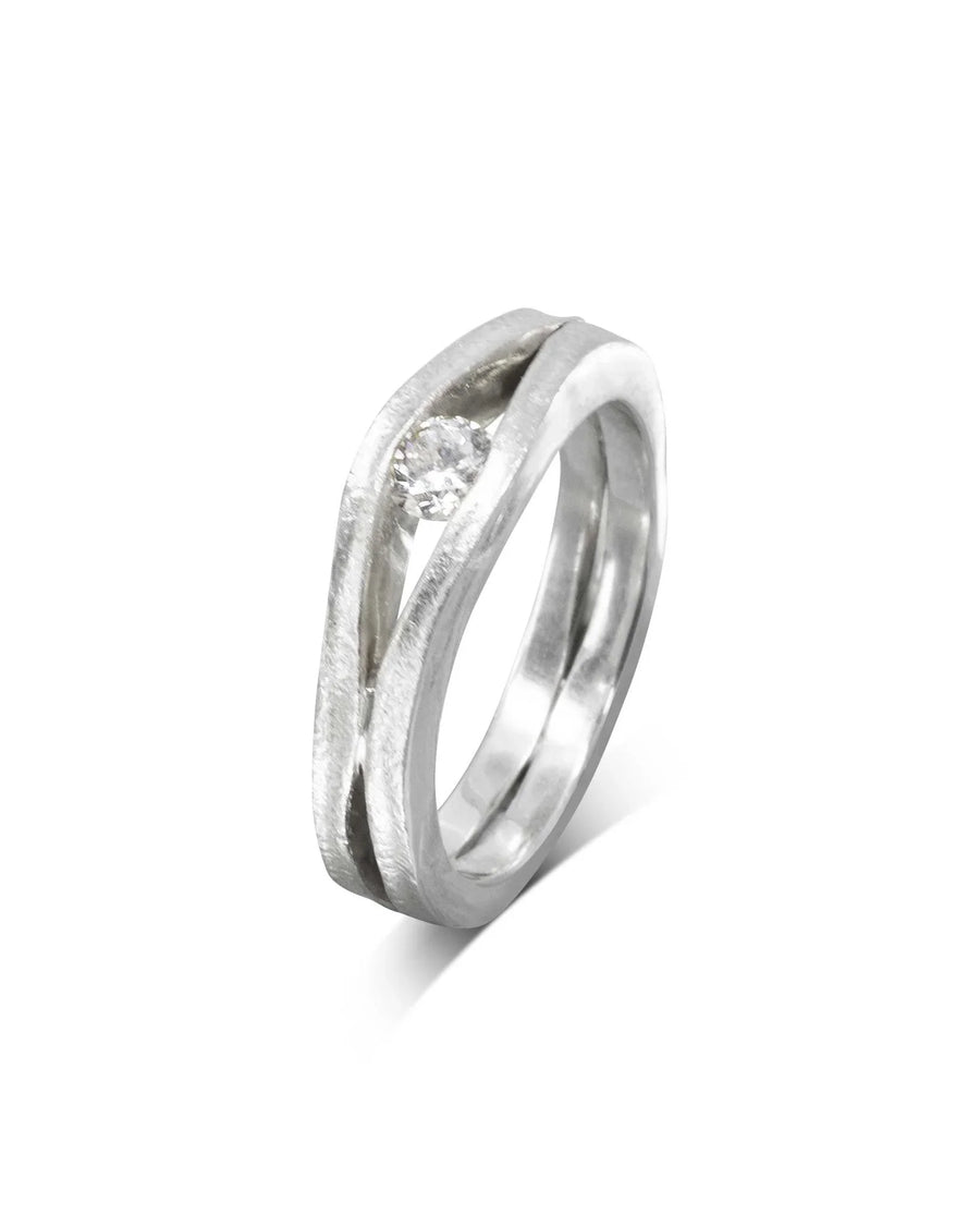 Platinum engagement ring with a round diamond in a trap solitaire design.