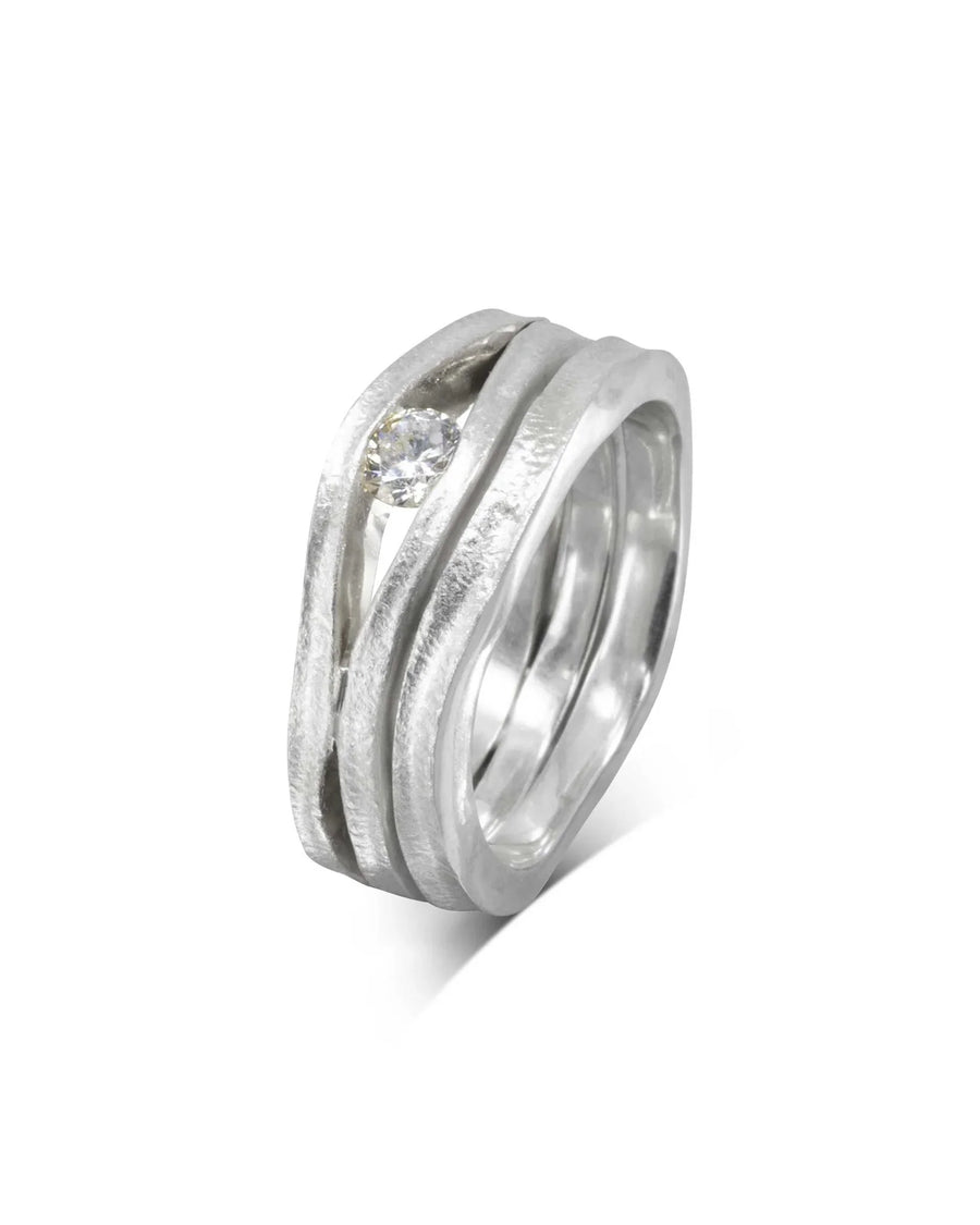 Platinum diamond trap solitaire engagement ring with a textured, wavy band.