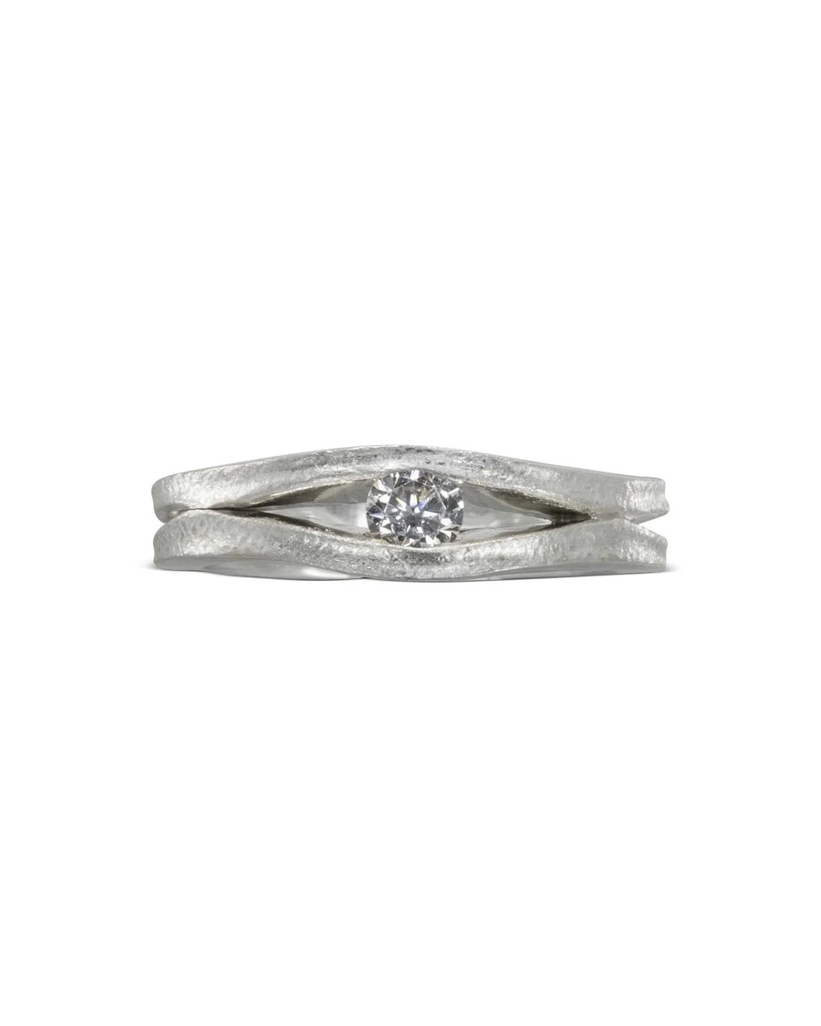 Platinum diamond trap solitaire engagement ring with a textured band.