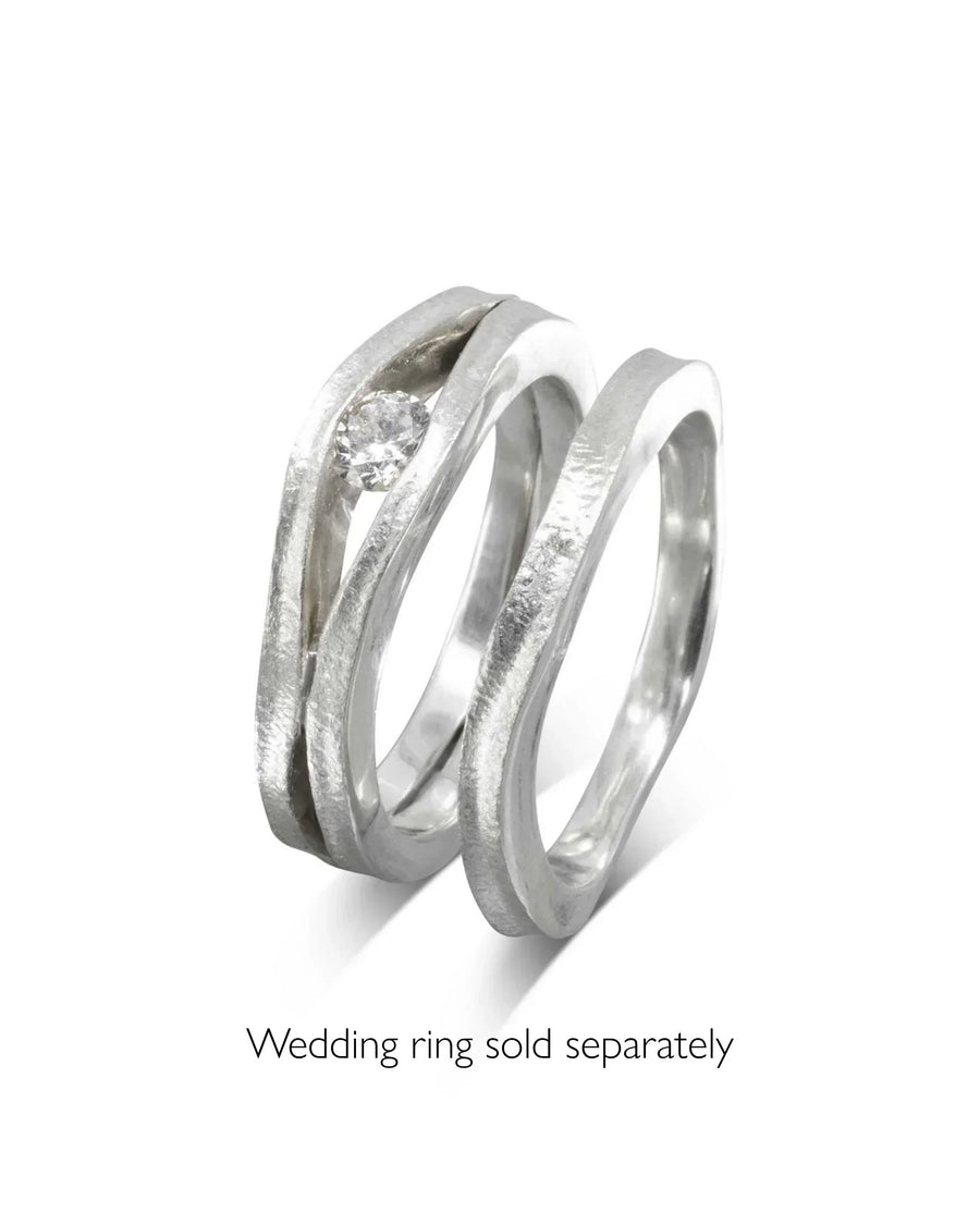 Platinum diamond trap solitaire engagement ring with a matching curved band.