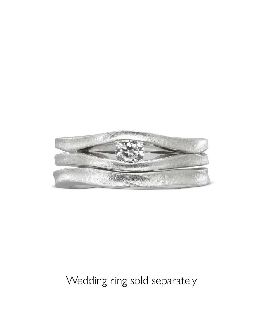 Platinum diamond trap solitaire engagement ring with a textured band.