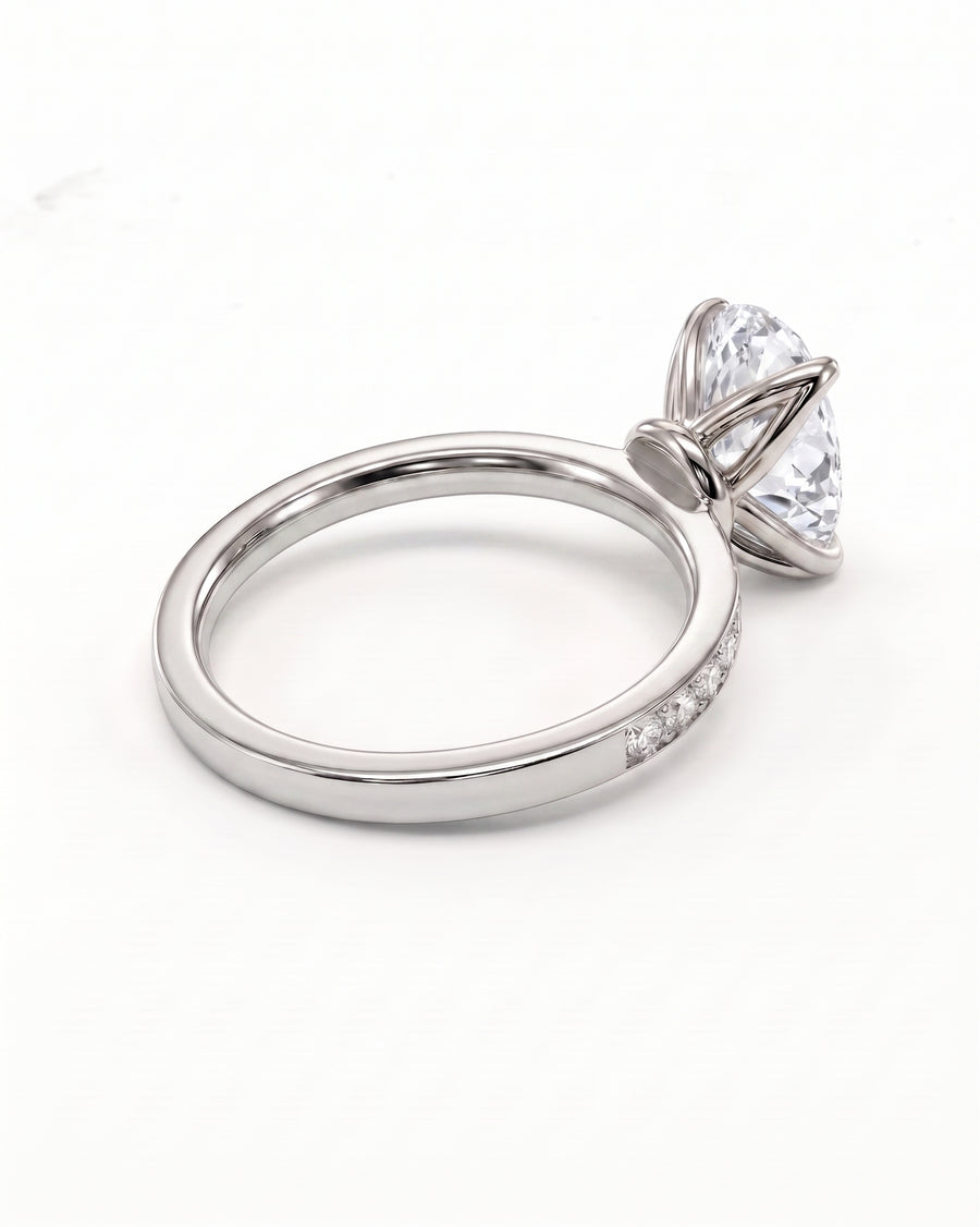 A platinum diamond engagement ring featuring a large marquise-cut center stone in a four-prong setting, with a slim pavé band, shown on a clean white background.