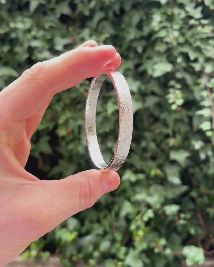 solid silver rectangular bangle being rotated
