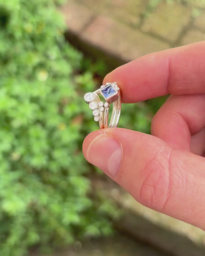 bubbles engagement ring and wedding ring set rotating by hand