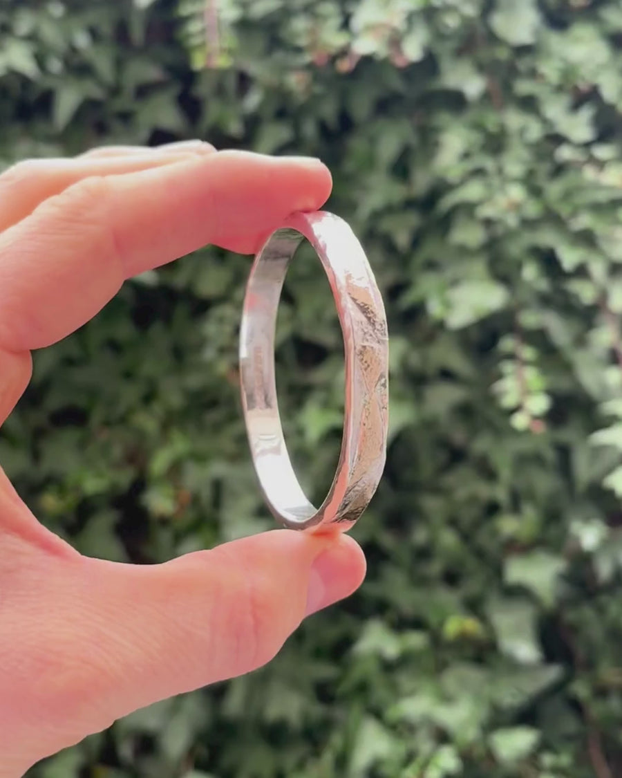 silver & gold bangle being held