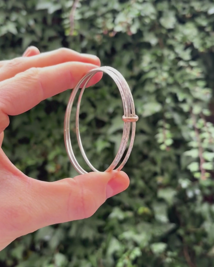  triple silver bangle with gold hoop being rotated